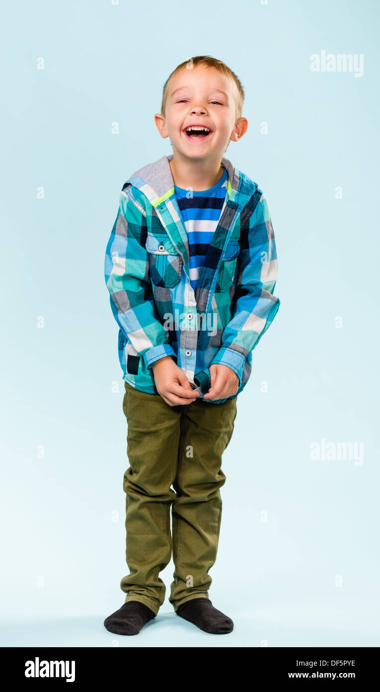Playful little boy on studio, light blue background Stock Photo - Alamy