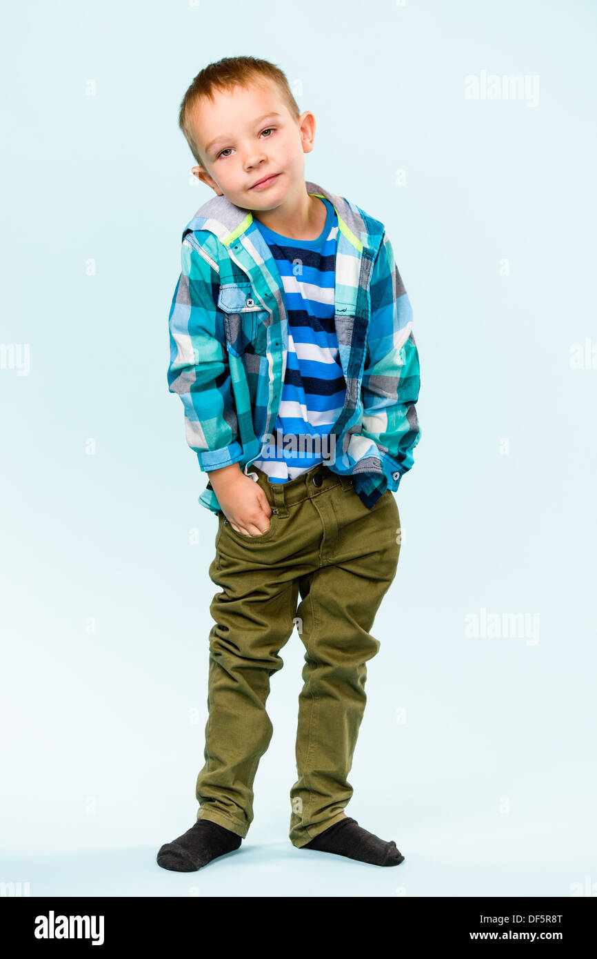Playful little boy on studio, light blue background Stock Photo - Alamy