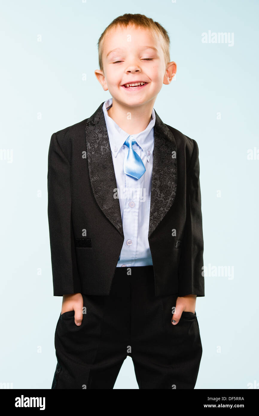 Handsome little boy posing on studio, light blue background Stock Photo ...