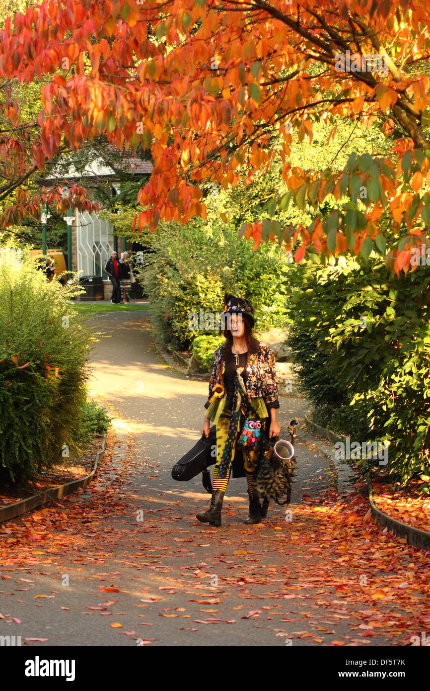Derbyshire, UK. 28 Sept 2013.  Member of the Official Monster Raving Loony Party and Black Pig Border Morris, Ruth Wint strolls through an Autumnal scene in the Derwent Gardens at Matlock Bath, Derbyshire on the second day of the Official Monster Ravinng Loony Party annual conference and Steampunk Illuminata event. Credit:  Matthew Taylor/Alamy Live News Stock Photo