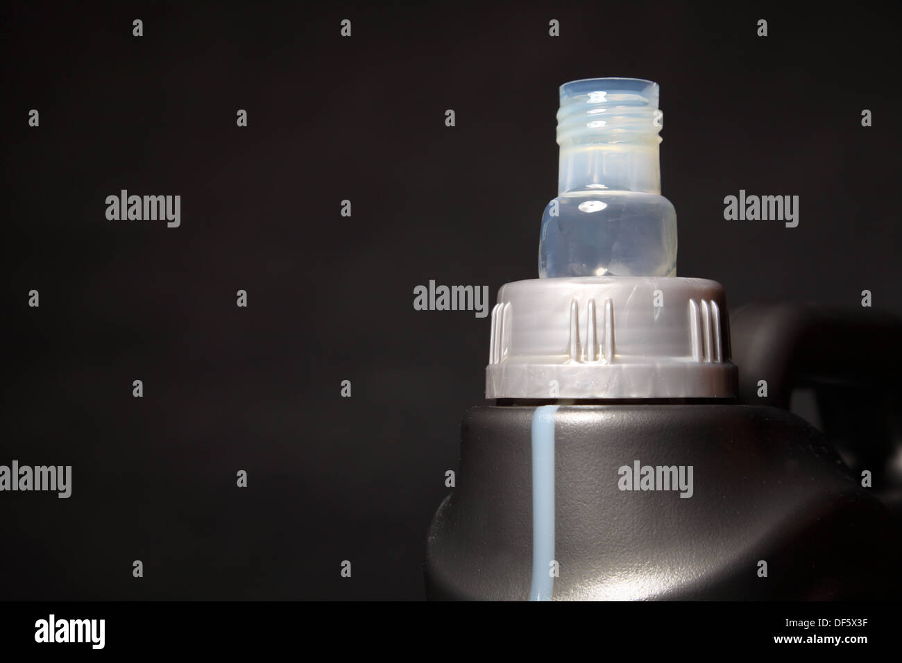 Closeup gray canister with car engine oil black background Stock Photo