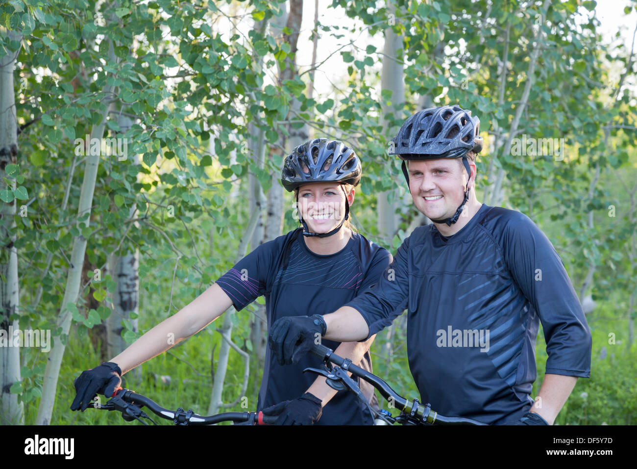 married couple with mountain bikes outdoors in Montana Stock Photo