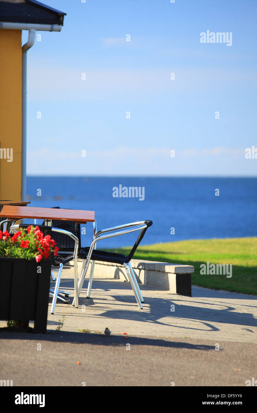 Seaside Table And Chairs In Front Of A Old House Country