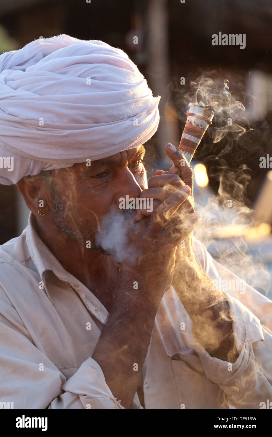 India, Rajasthan, Jodhpur, tribesman smoking opium Stock Photo