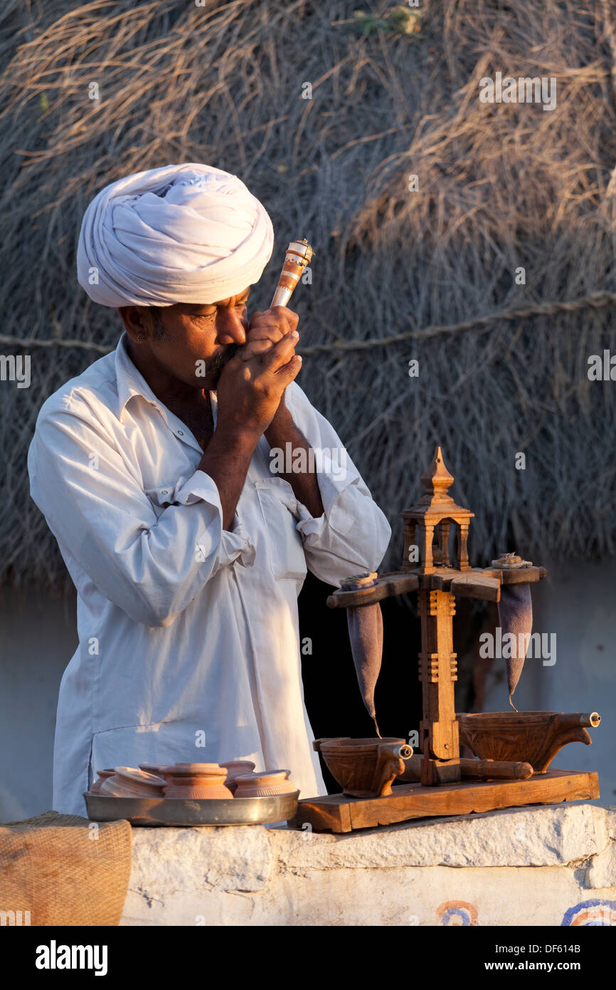 India, Rajasthan, Jodhpur, tribesman smoking opium in early morning light Stock Photo