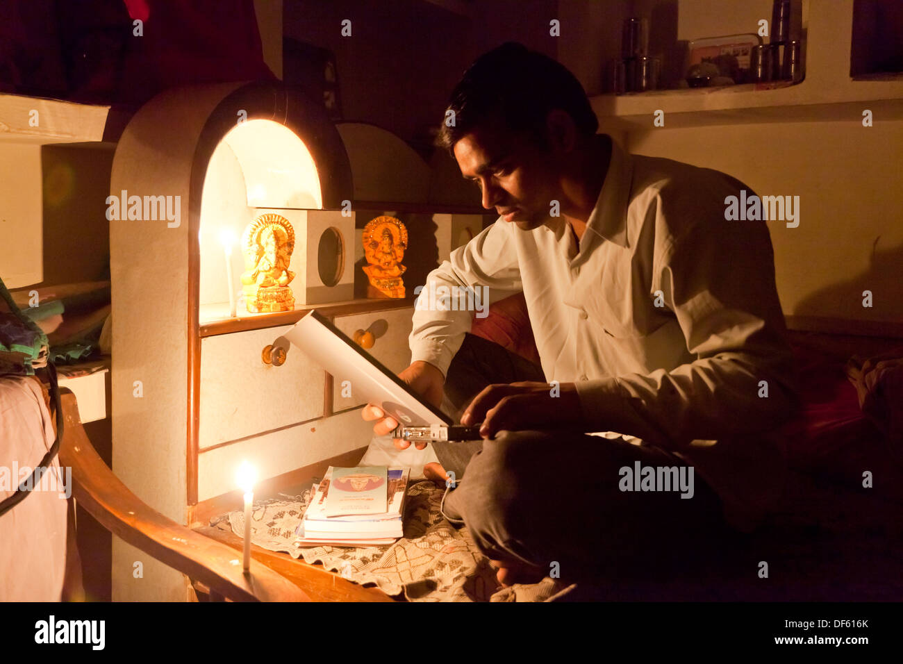 India, uttar Pradesh, Agra Young male using laptop computer by candlelight Stock Photo