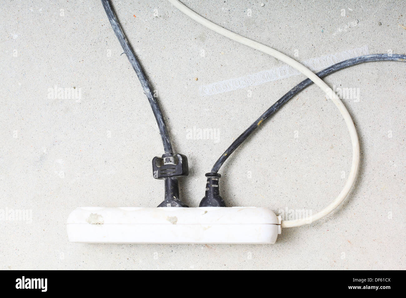 electrical cords connected to a power strip or extension block in construction site Stock Photo