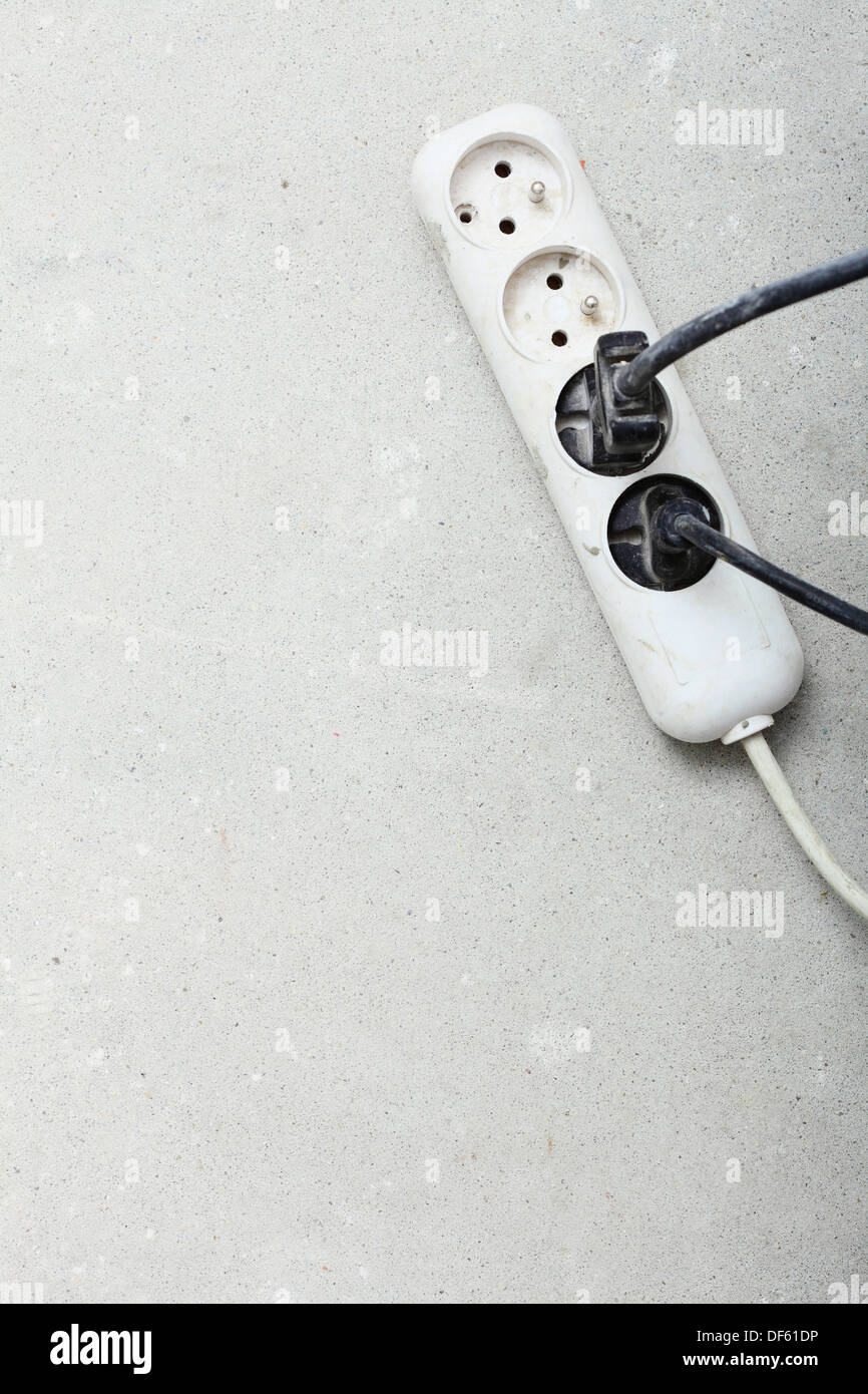 electrical cords connected to a power strip or extension block in construction site Stock Photo