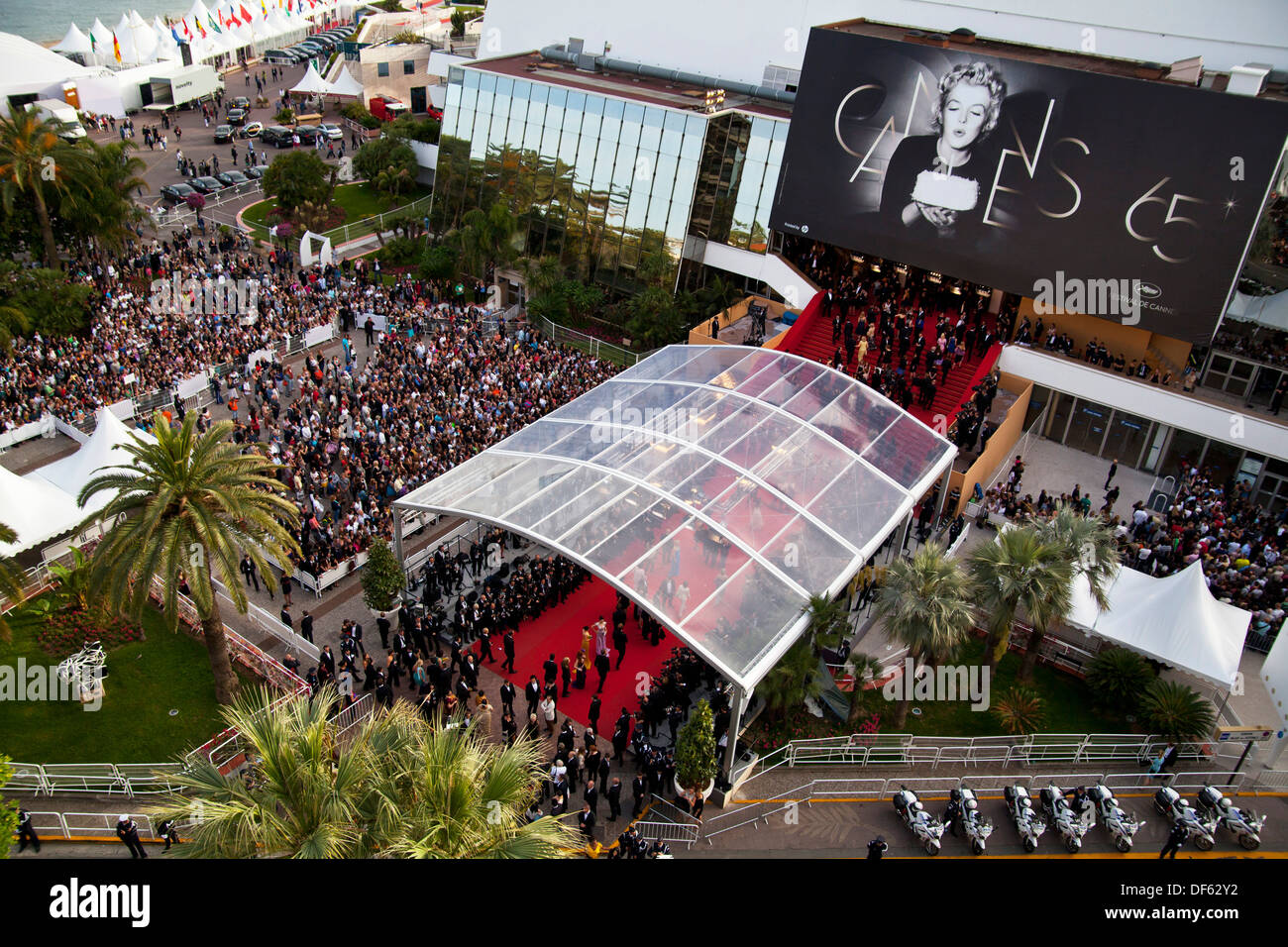 A huge crowd watches celebrities walk down the red carpet at Cannes Film Festival Stock Photo
