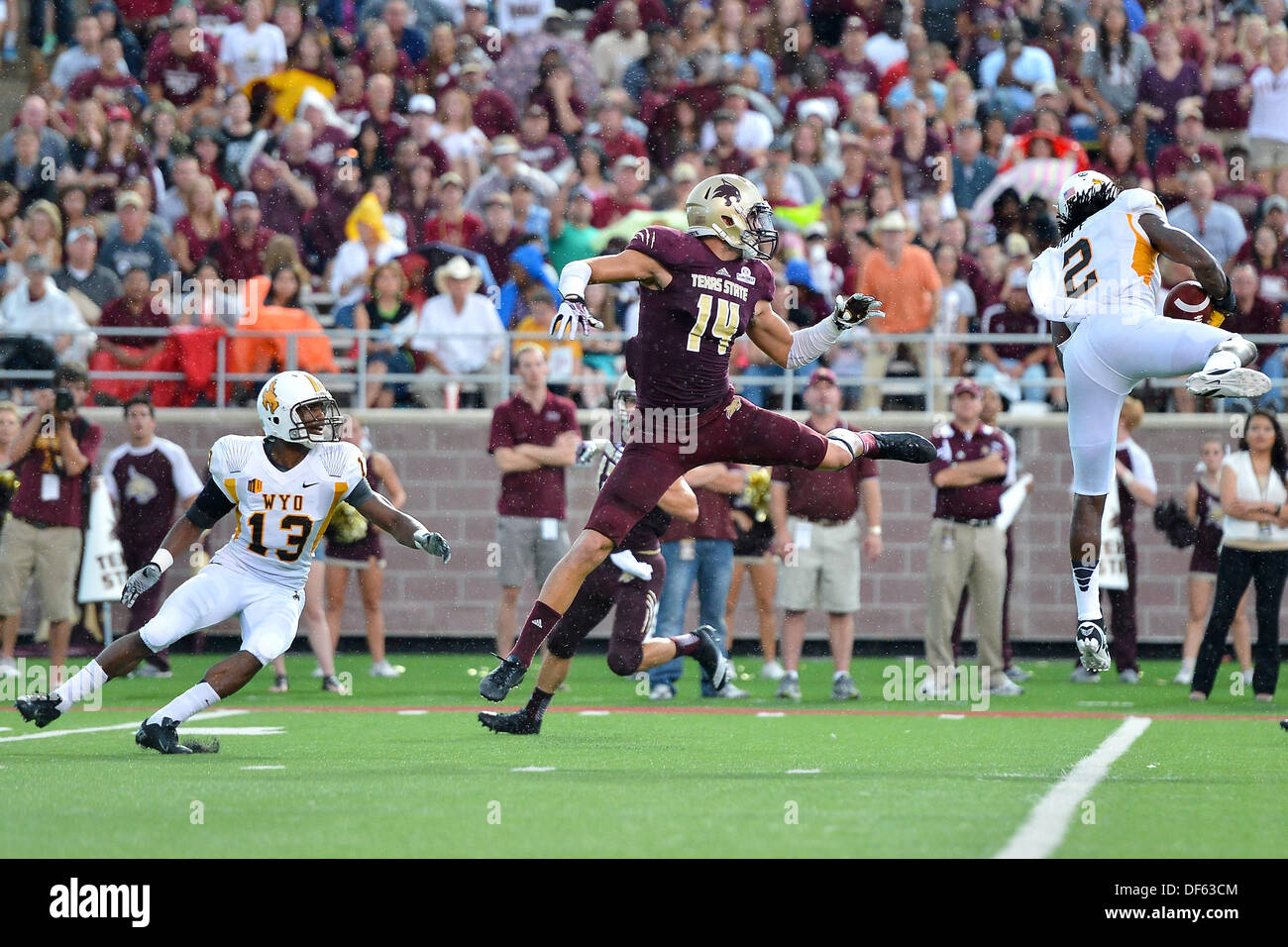 San Marcos, TX, USA. 28th Sep, 2013. Wyoming cornerback Marqueston Huff #2 intercepts a pass intended for Texas State wide receiver Montreal Taylor #14 during NCAA football game at Jim Wacker Field in San Marcos, TX. Texas State and Wyoming was tied at 7-7 midway through the second quarter when game was suspended due to inclement weather. © csm/Alamy Live News Stock Photo