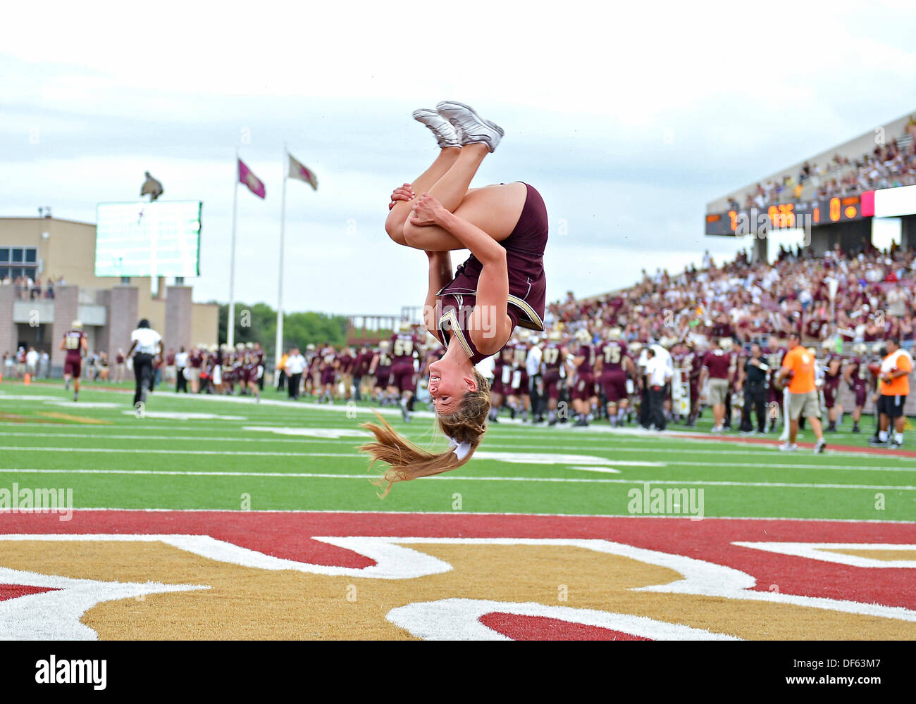San Marcos, TX, USA. 28th Sep, 2013. Texas State cheerleader performs a celebratory back flip after scoring drive during NCAA football game at Jim Wacker Field in San Marcos, TX. Texas State defeat Wyoming 42-21. © csm/Alamy Live News Stock Photo
