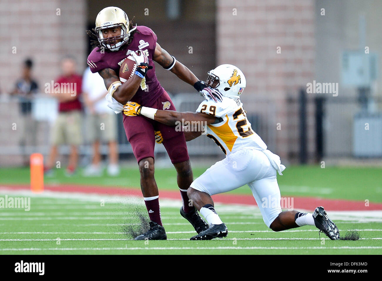 San Marcos, TX, USA. 28th Sep, 2013. Texas State wide receiver Ben Ijah #1 is defended by Wyoming cornerback Tim Hayes #29 during NCAA football game at Jim Wacker Field in San Marcos, TX. Texas State defeat Wyoming 42-21. © csm/Alamy Live News Stock Photo