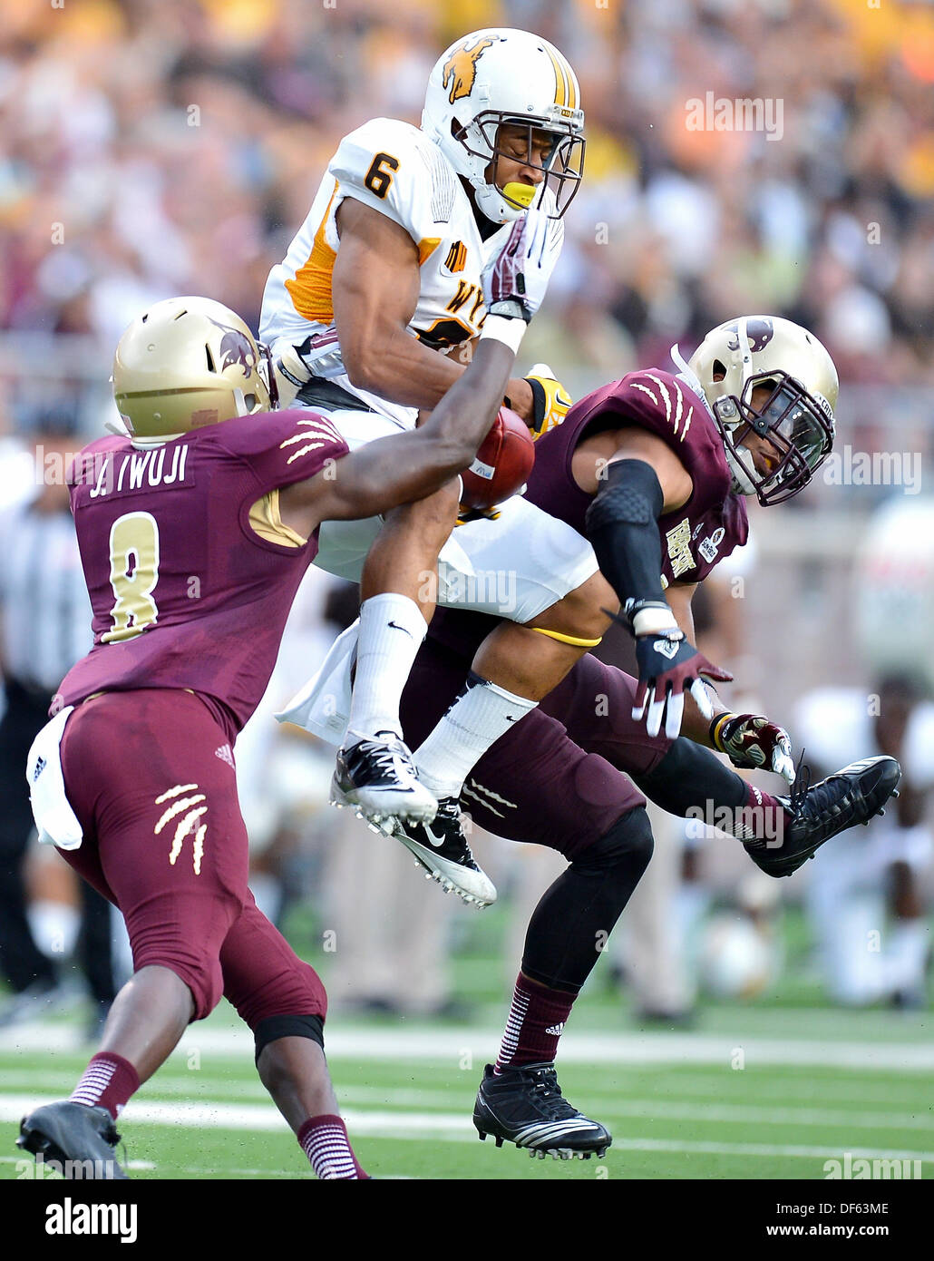 San Marcos, TX, USA. 28th Sep, 2013. Texas State safety Justin Iwuji #8 breaks a pass intended for Wyoming wide receiver Robert Herron #6 during NCAA football game at Jim Wacker Field in San Marcos, TX. Texas State defeat Wyoming 42-21. © csm/Alamy Live News Stock Photo
