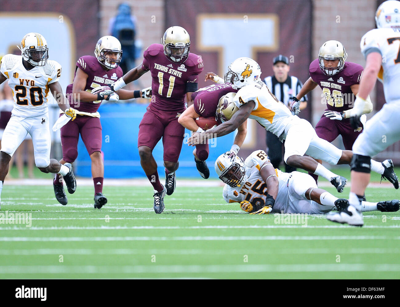 San Marcos, TX, USA. 28th Sep, 2013. Texas State wide receiver Andy Erickson #13 is tackled by Wyoming cornerback DeAndre Jones #4 during NCAA football game at Jim Wacker Field in San Marcos, TX. Texas State defeat Wyoming 42-21. © csm/Alamy Live News Stock Photo