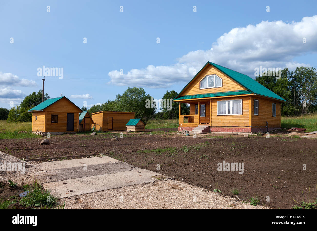 New wooden house at the village in summertime Stock Photo