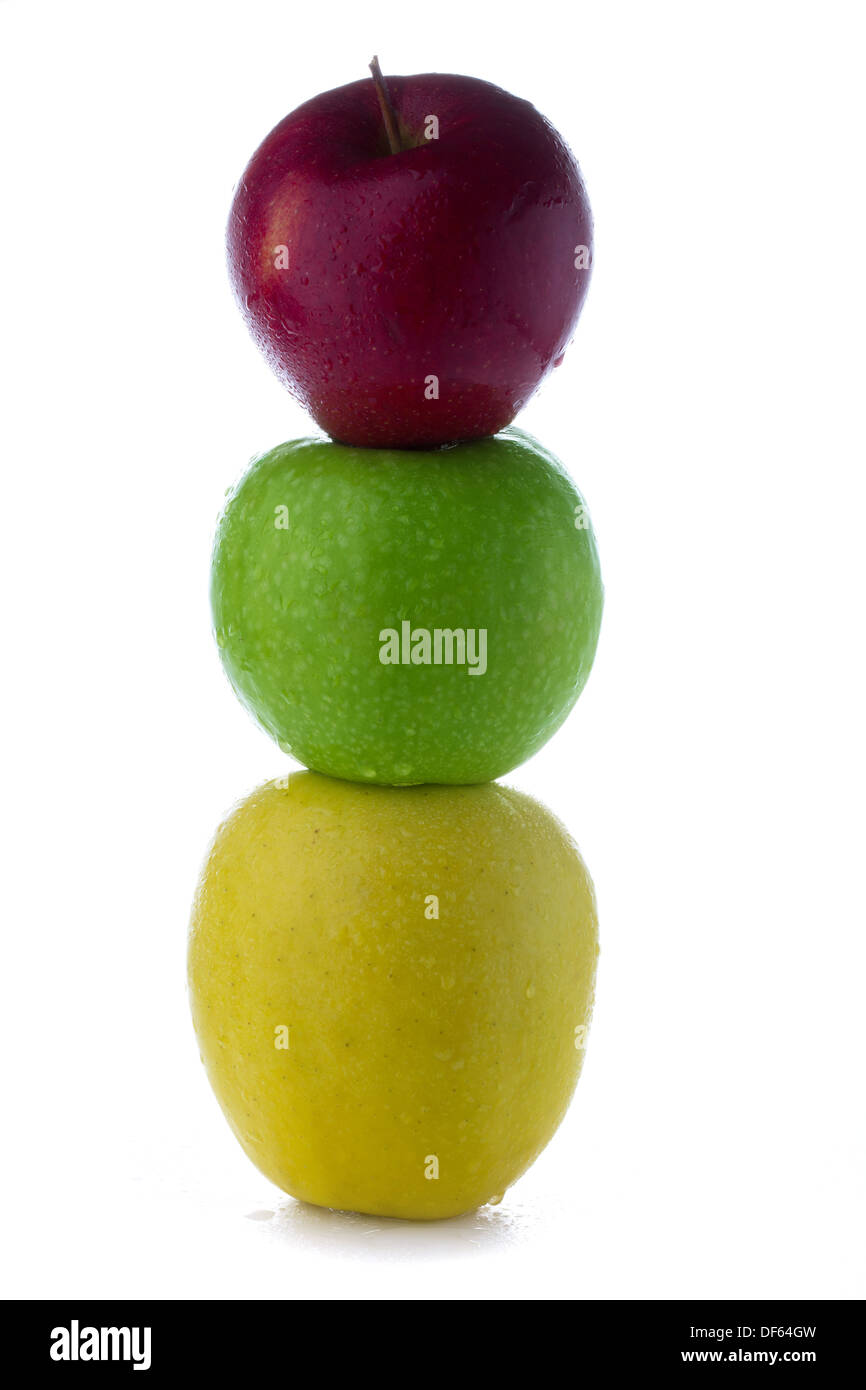 fresh green yellow red apples in the form of a traffic light isolated on a white background