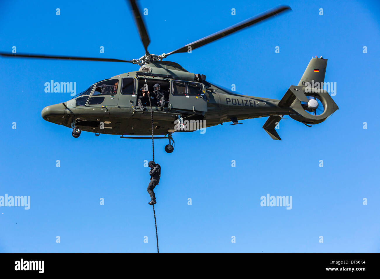Police SWAT Team, fast roping from a police helicopter. Stock Photo