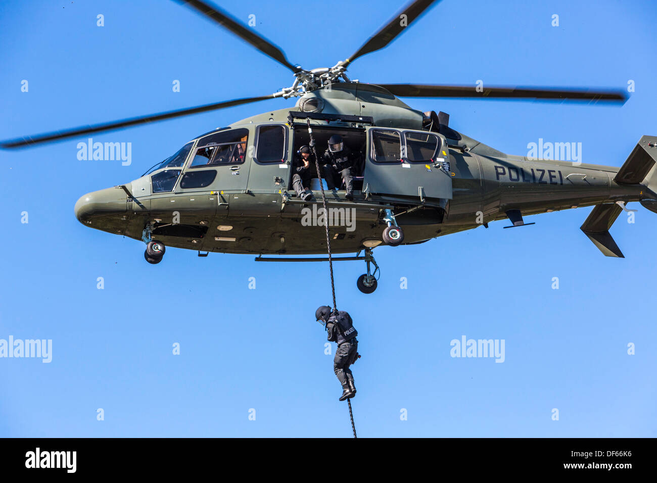 Police SWAT Team, fast roping from a police helicopter. Stock Photo