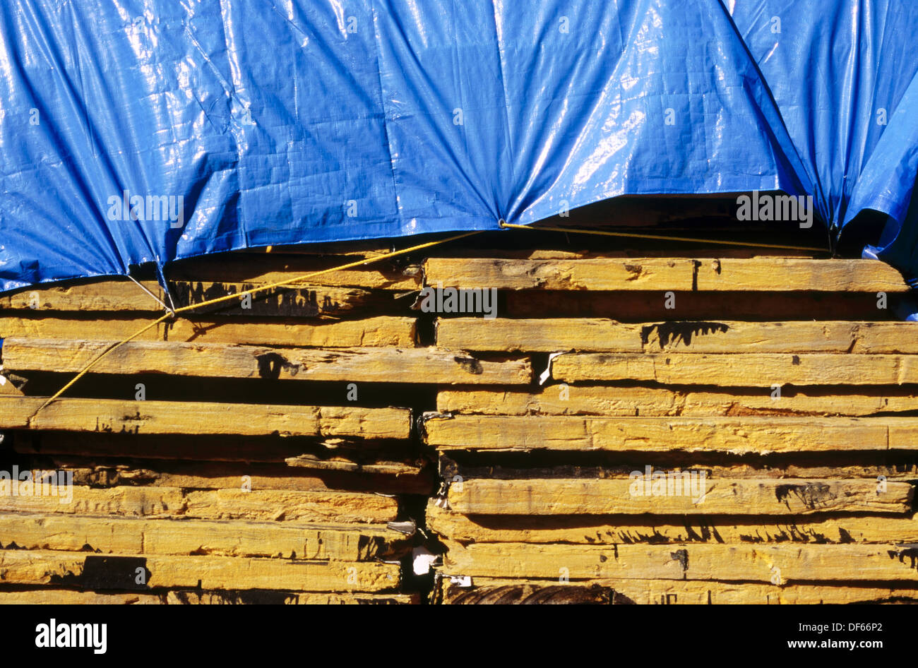 Stacked yellow foam insulation panels and blue tarp Stock Photo Alamy