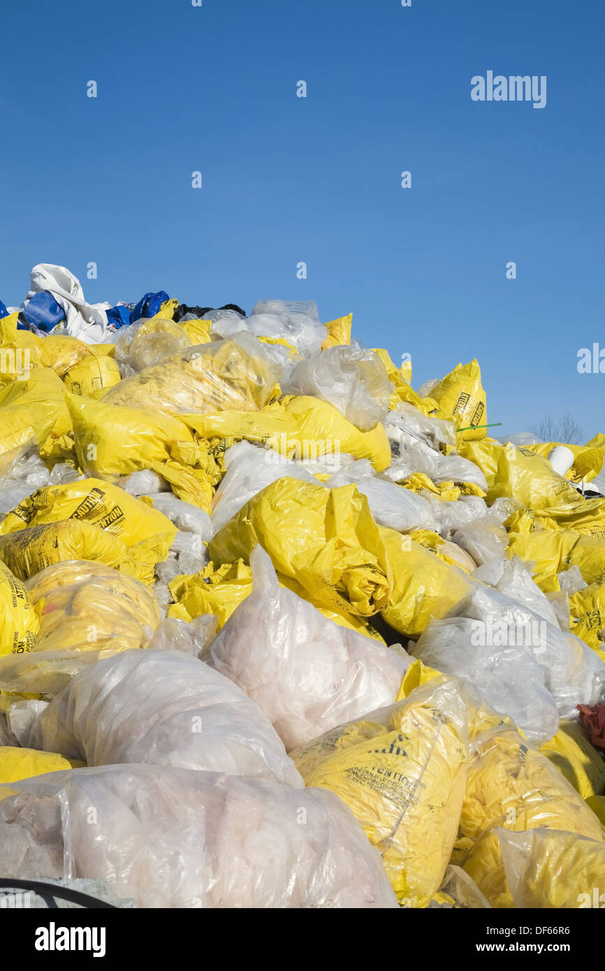 Discarded plastic bags filled with asbestos fibres at a recycling yard