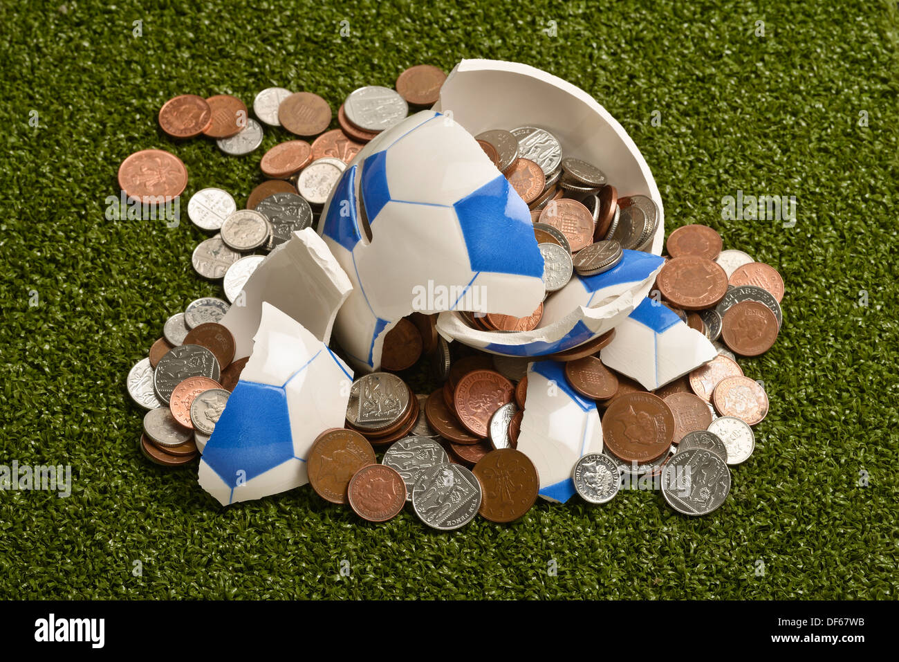 Smashed and broken football piggy bank money Stock Photo
