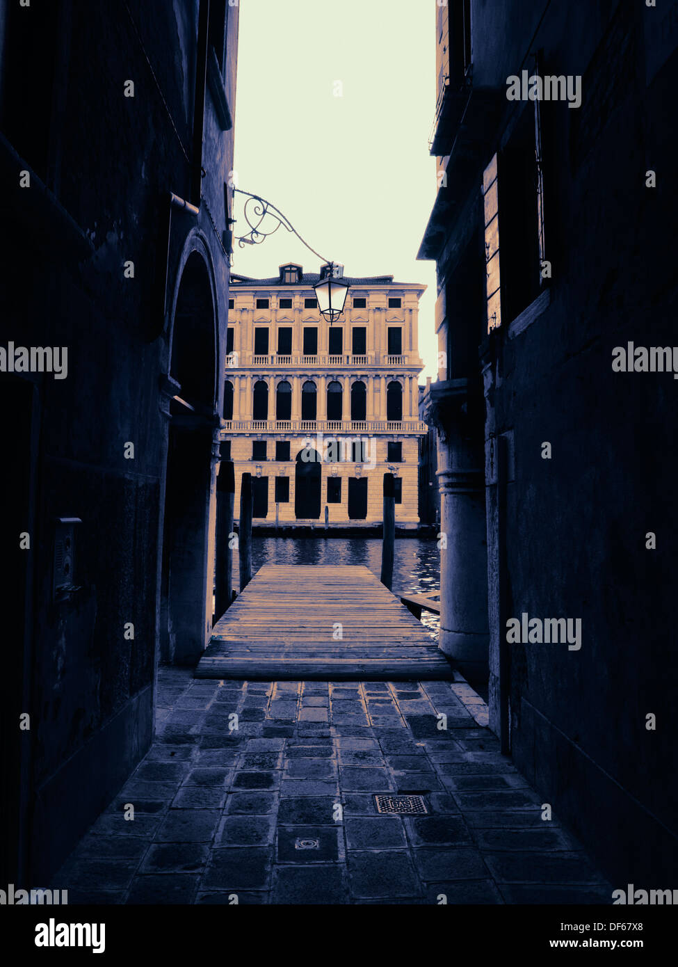 Dark narrow passage leading to canal, Venice, Italy Stock Photo