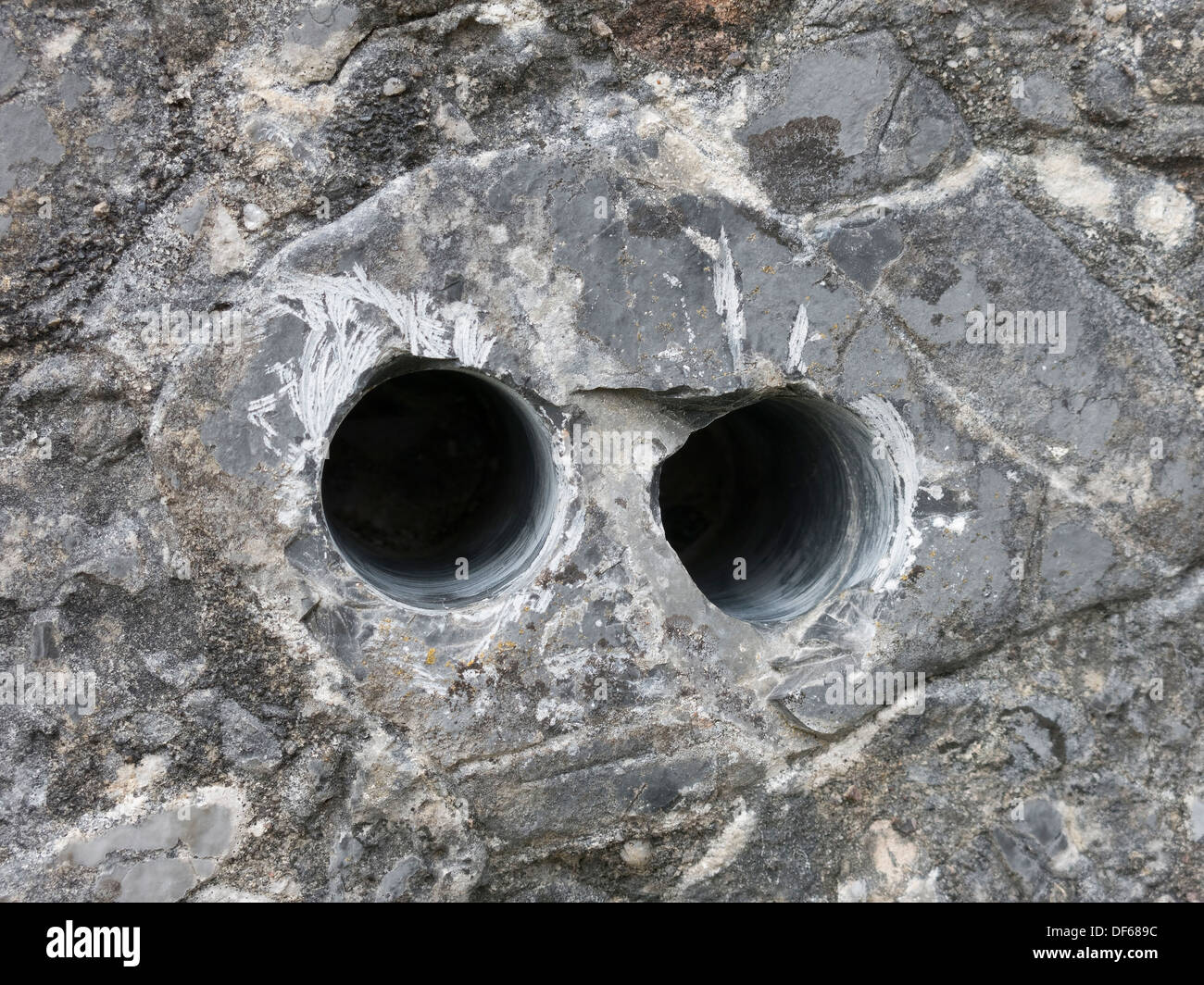 Geology core sample drill holes in pudding stone conglomerate rock, Boreraig, Isle of Skye, Scotland, UK. Stock Photo