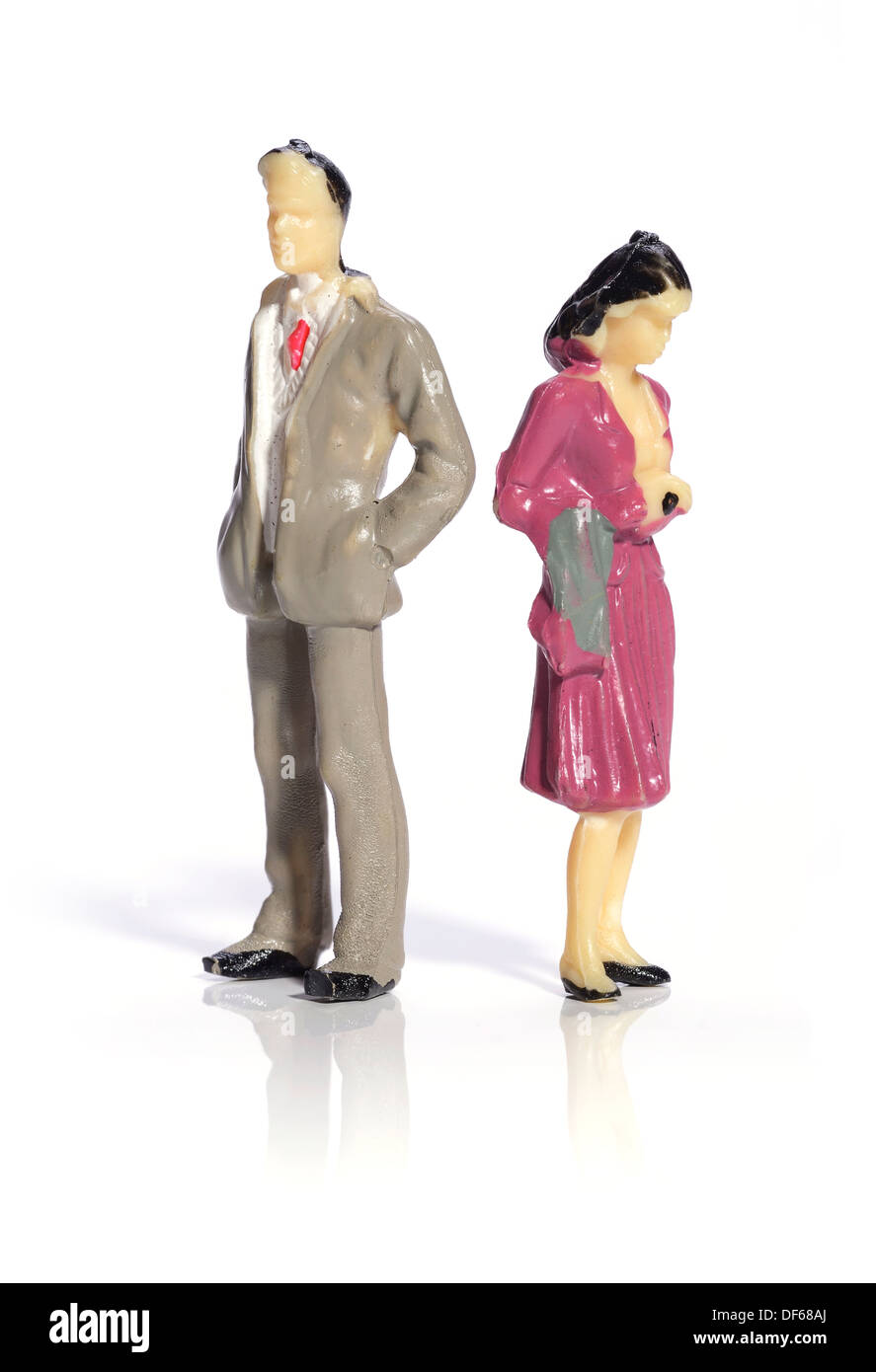 Mini plastic man and woman facing away from each other Stock Photo