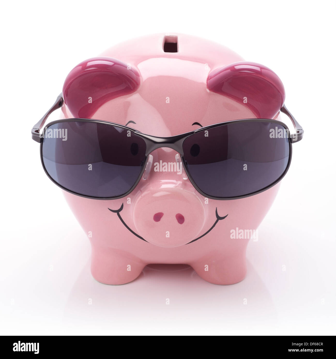 Pink ceramic piggy bank wearing sunglasses Stock Photo