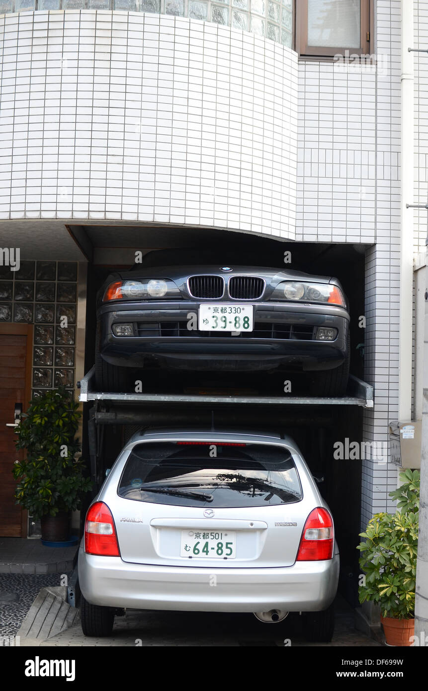 One car parked above another in Japan. Stock Photo