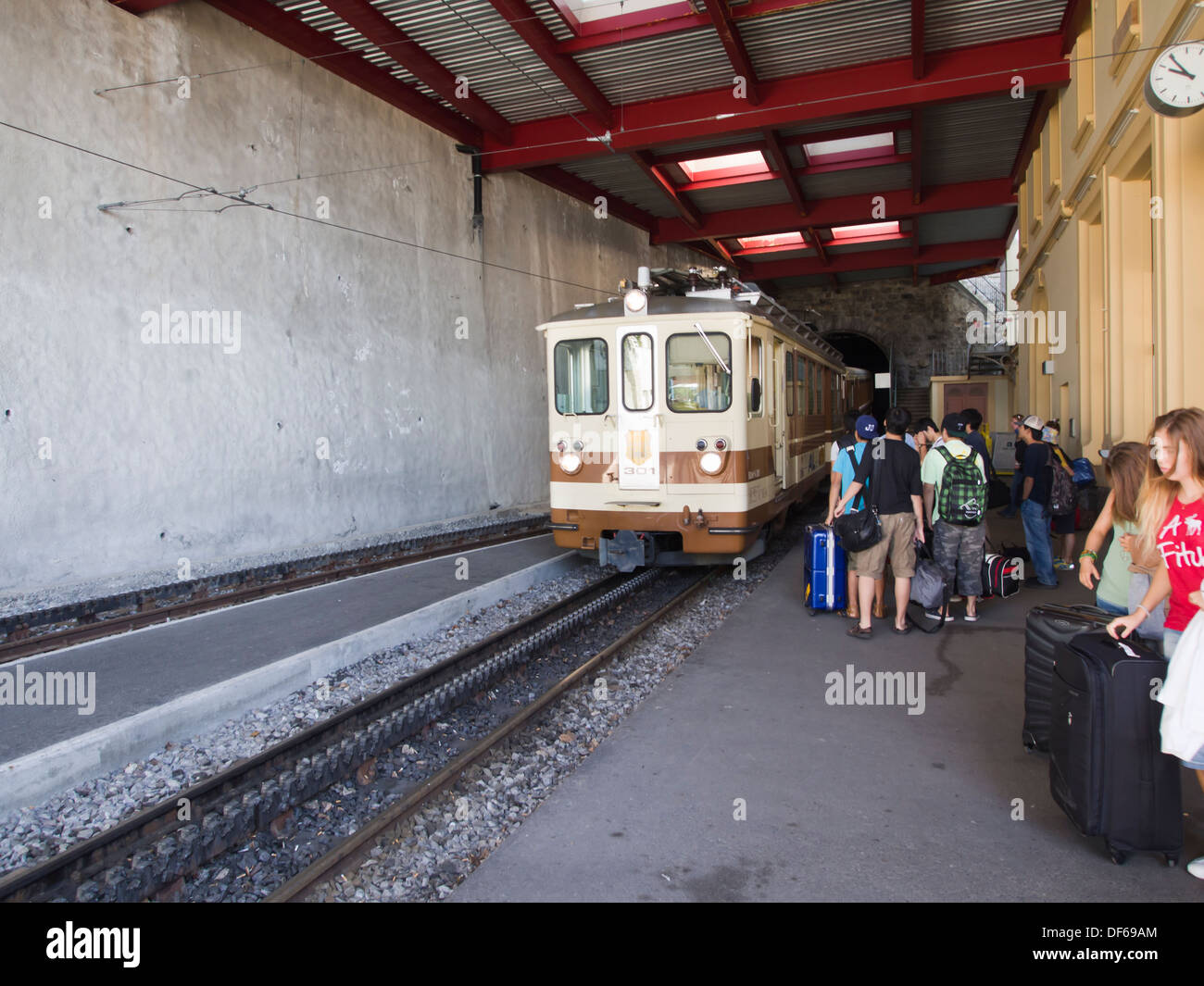 Aigle Leysin railway in the Vaud canton of Switzerland, passengers boarding the train in the Feydey station Stock Photo