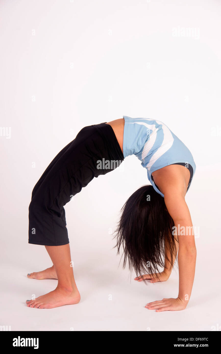 Flexible young woman bent over backwards Stock Photo