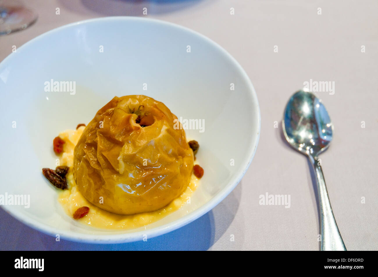 Dessert: Roast apple with cream. Close view. Stock Photo