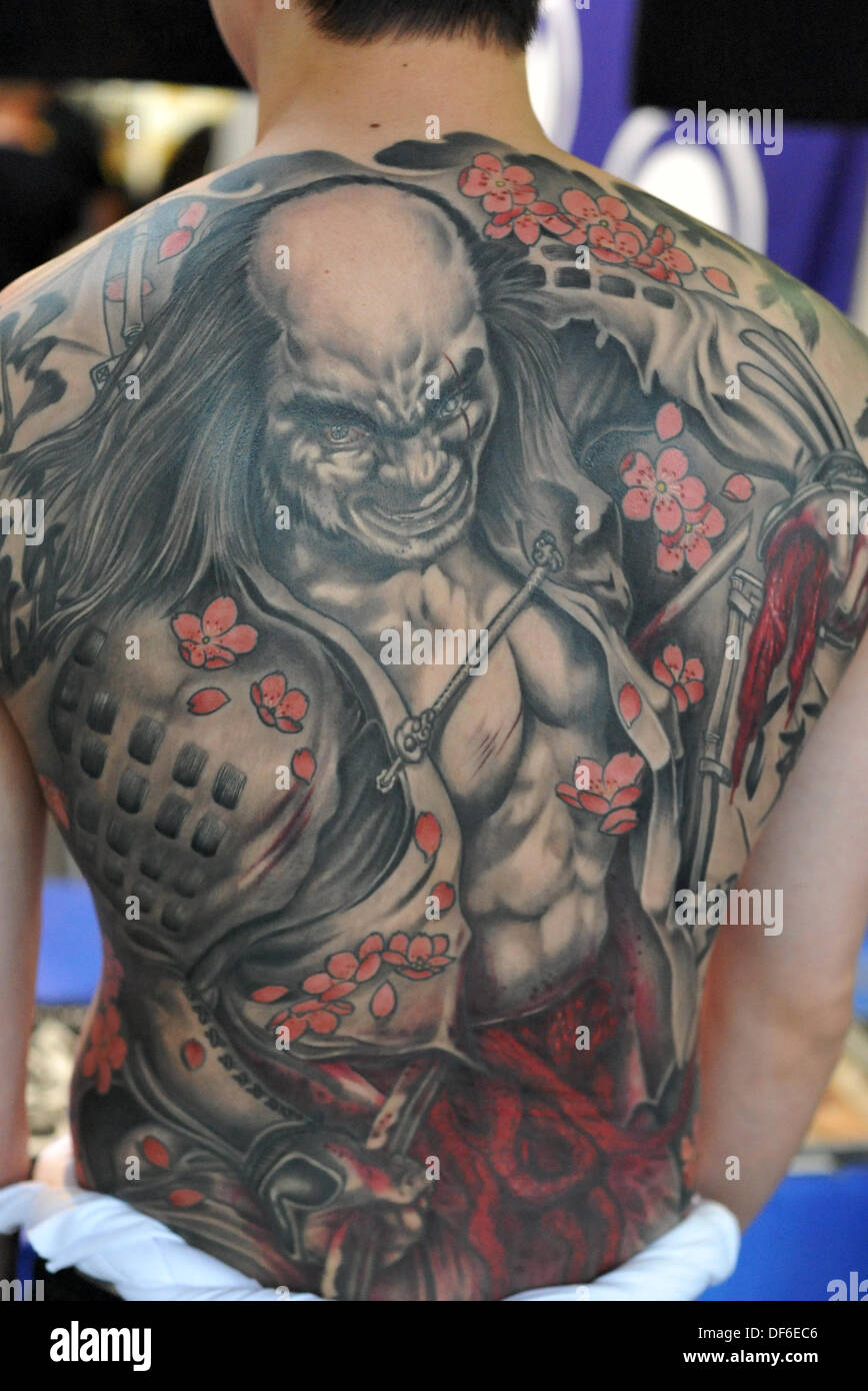 London, UK. 28 Sept 2013. A dramatic, Japanese style, whole back tattoo featuring the act of seppuku at the 9th International London Tattoo Convention. Whole back tattoos are normally very involved and can take 20 hours or more to complete. © Michael Preston/Alamy Live News Stock Photo