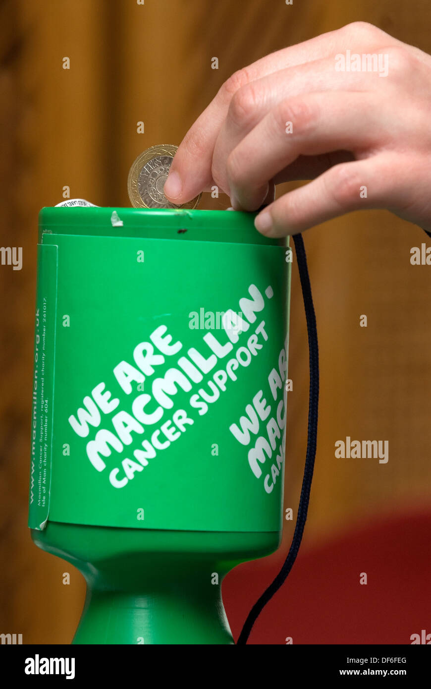Making a £2 donation to Macmillan Cancer Support, Surrey, UK. Stock Photo