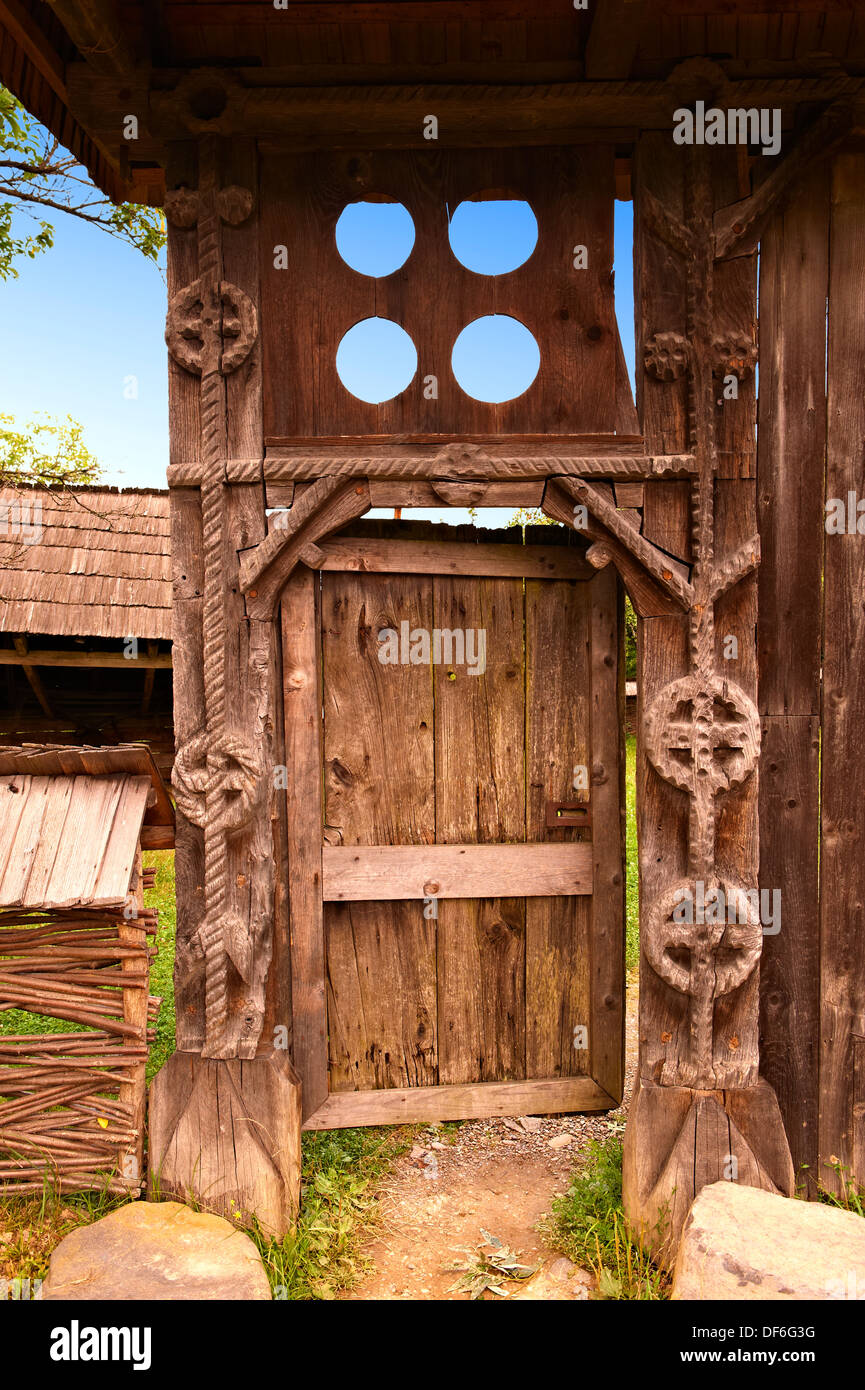 19th century traditional Iza Valley farm house carved wooden folk art gates, The Village museum near Sighlet, Maramures, Norther Stock Photo
