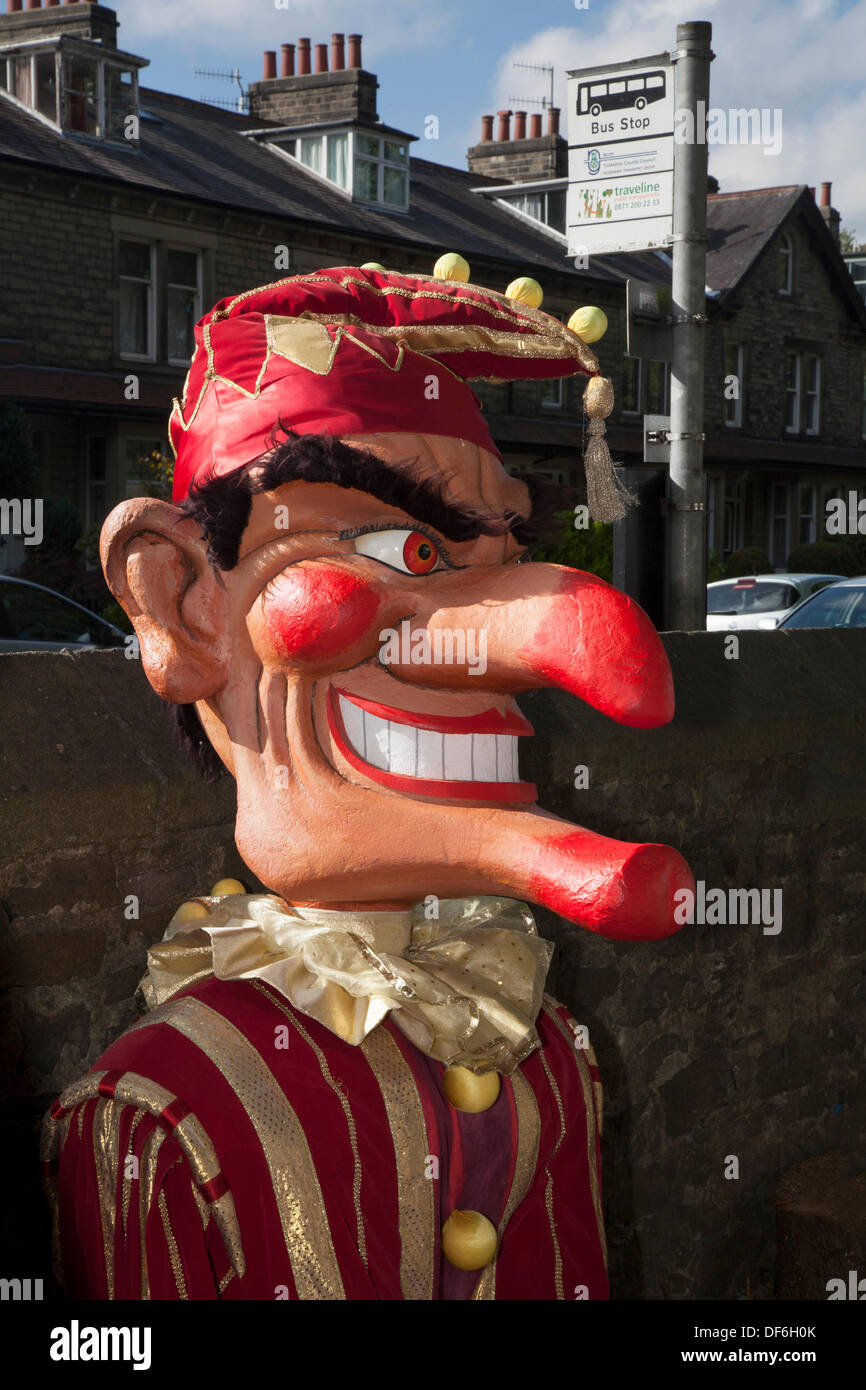 Giant puppet caricature masquerade celebration at Skipton UK. 29th September, 2013. International Puppet Festival.  Giant scary Punch & Judy Puppets at Skipton's biennial international puppet festival featuring theatre companies from all over Europe with giant puppets animated with hands, feet, toys,  shadows and with a puppet show, punch, performance, theatre stage entertainment, children, traditional, clown, fun, play, judy, red, sign, doll, funny, colourful, event, summer, jester, puppets, sky, wooden giants. Stock Photo