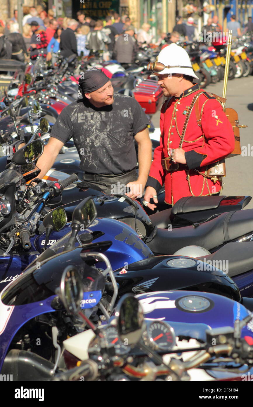 Matlock Bath, Derbyshire, UK. 29 Sept 2013.  (L-R) Motorbiker, Royce Sims from Derby chats about his customized Suzuki Hayabusa with steampunk, Tony Lightowler, a nuclear engineer from Stockton-on-Tees during the second annual Steampunk Illuminata event at Matlock Bath, a Victorian spa town in Derbyshire that is a hugely popular meeting places with bikers. The steampunk sub-culture emerged from a genre of science-fiction literature and has come to develop its own music and pseudo-Victorian fashion styles. Credit:  Matthew Taylor/Alamy Live News Stock Photo
