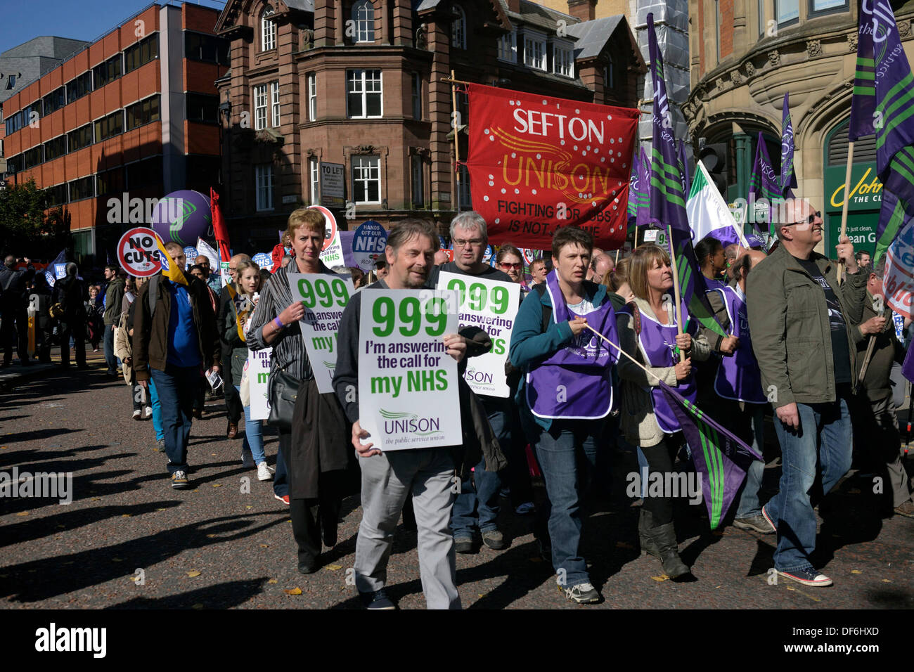 Supporters of the NHS and UNISON are among the tens of thousands of protesters at the TUC demonstration against the Coalition Government's policy on the NHS, jobs and austerity. The protest coincides with the first day of the Conservative Party Conference in Manchester. TUC Protest  Manchester, UK  29 September 2013 Stock Photo