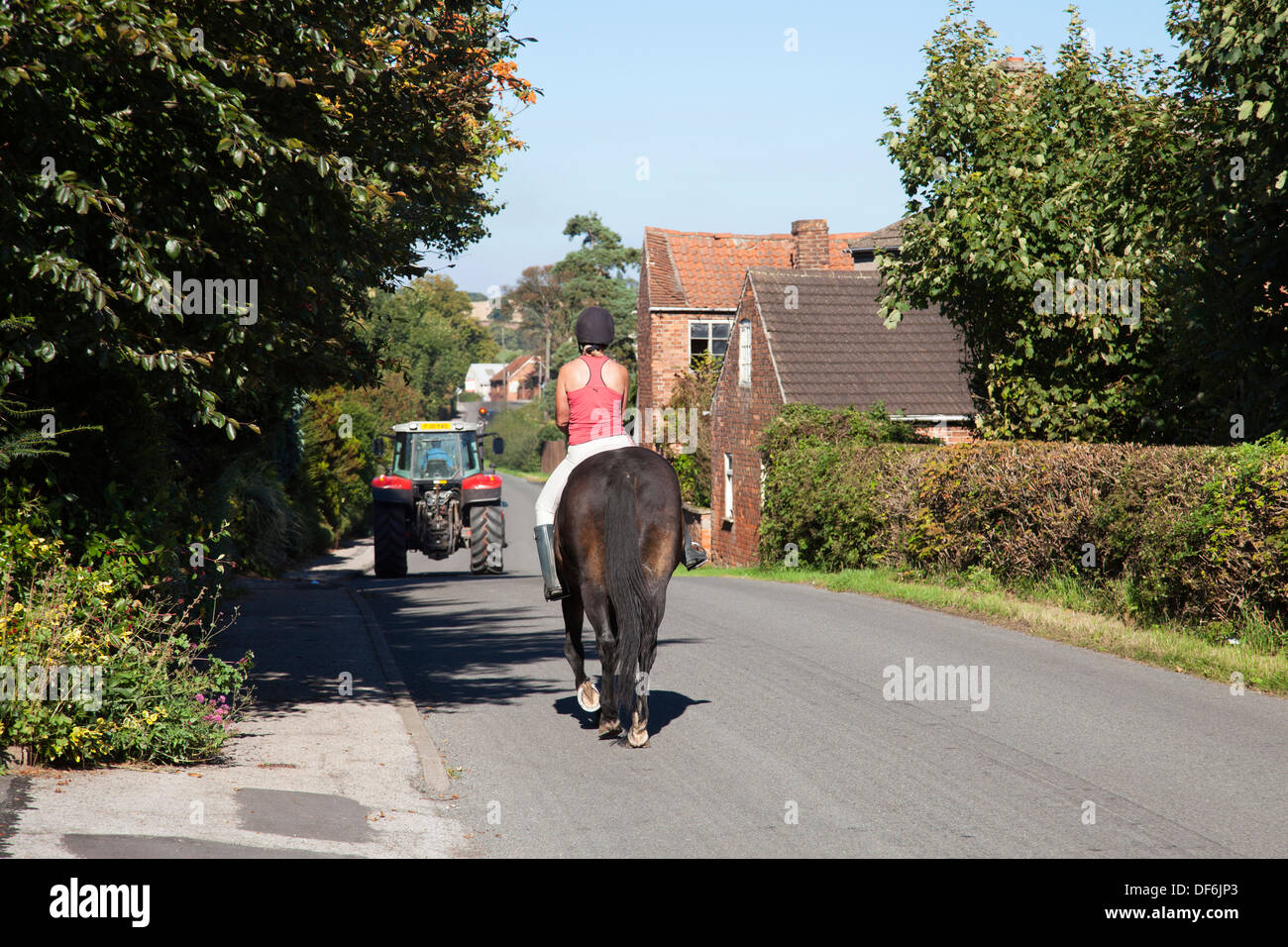A horse and rider on a rural road in the U.K. Stock Photo