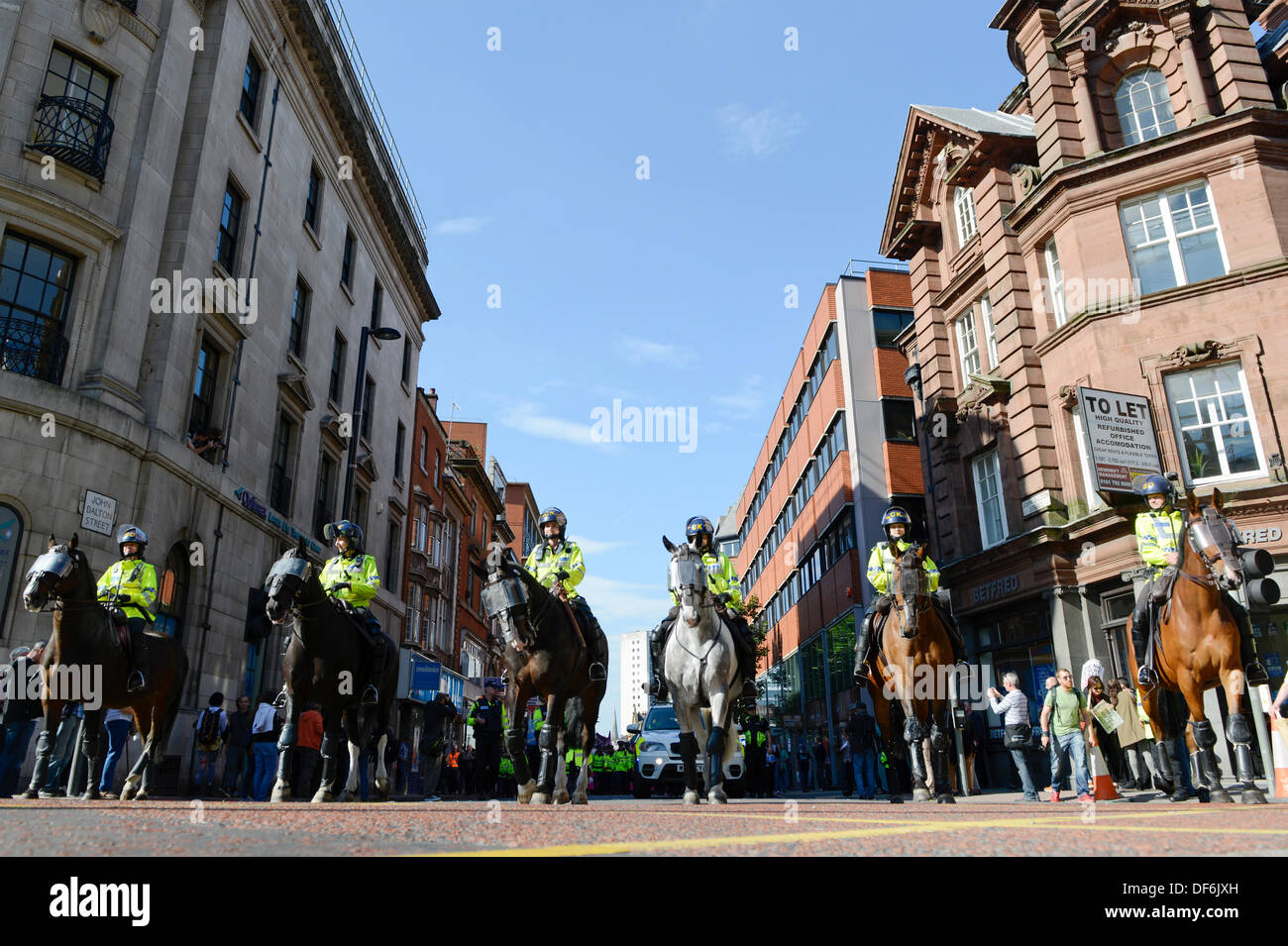 Manchester, UK. 29th Sept 2013. Horse mounted police make their way up Princess Street during a North West TUC organised march and rally intending to defend National Health Service (NHS) jobs and services from cuts and privatisation. The march coincides with the Conservative Party Conference 2013 being held in the city. Credit:  Russell Hart/Alamy Live News. Stock Photo