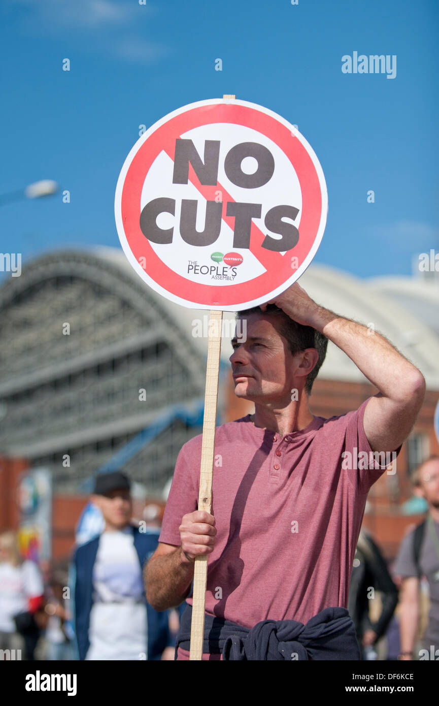 Manchester, UK. 29th Sept 2013. A man in his forties holding aloft a sign reading 'No cuts' during a North West TUC organised march and rally intending to defend National Health Service (NHS) jobs and services from cuts and privatisation. The march coincides with the Conservative Party Conference 2013 being held in the city. Credit:  Russell Hart/Alamy Live News. Stock Photo