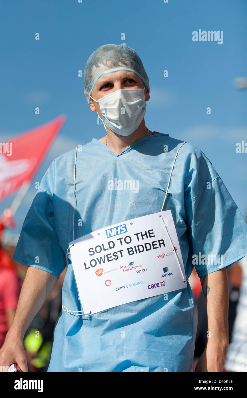 Manchester, UK. 29th Sept 2013. A male protester wearing a surgeon's uniform during a North West TUC organised march and rally intending to defend National Health Service (NHS) jobs and services from cuts and privatisation. The march coincides with the Conservative Party Conference 2013 being held in the city. Credit:  Russell Hart/Alamy Live News. Stock Photo