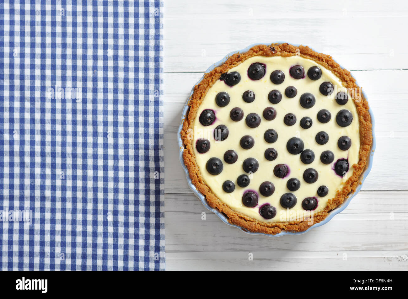 Blueberry tart on checkered background. Top view. Stock Photo