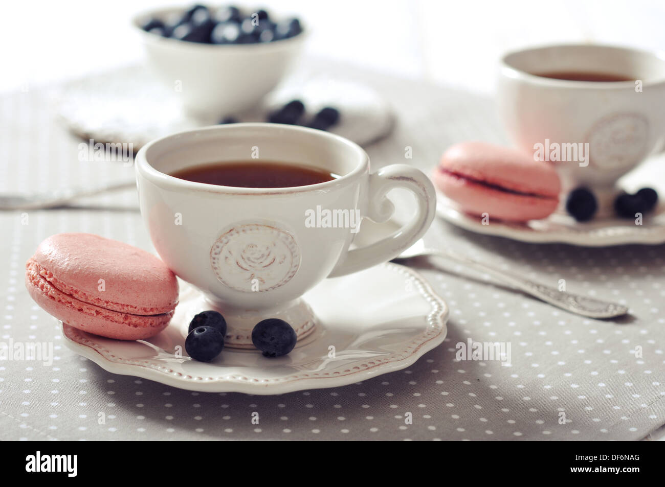 Tea with macaroon and fresh blueberry on beige background Stock Photo