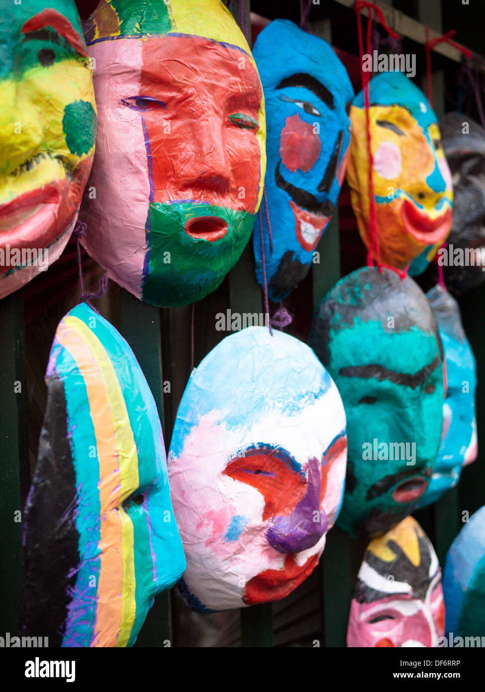 Colourful masks hanging for sale outside of a shop in the Old Quarter of Hanoi, Vietnam. Stock Photo