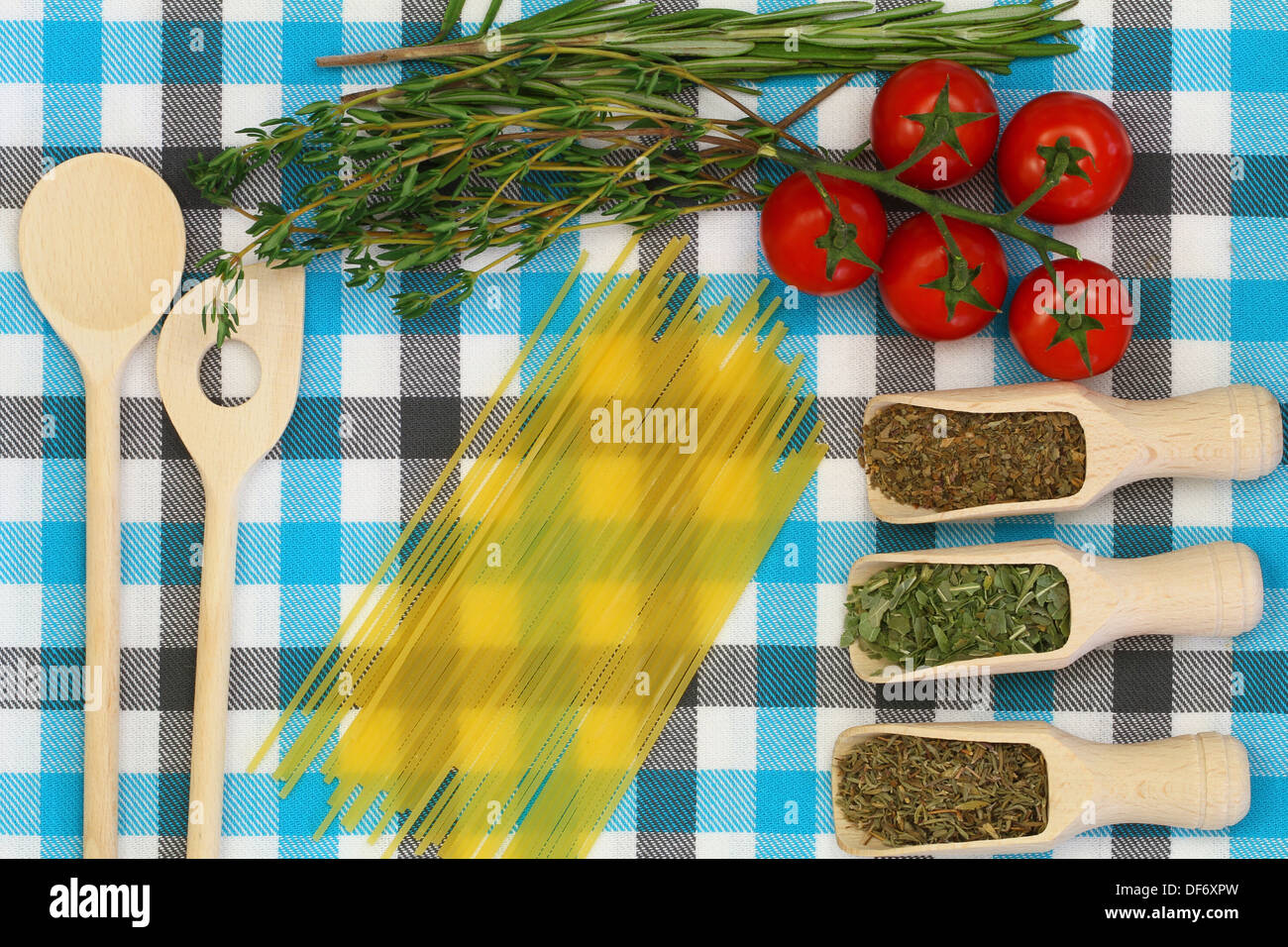 Selection of ingredients and herbs on checkered tablecloth Stock Photo