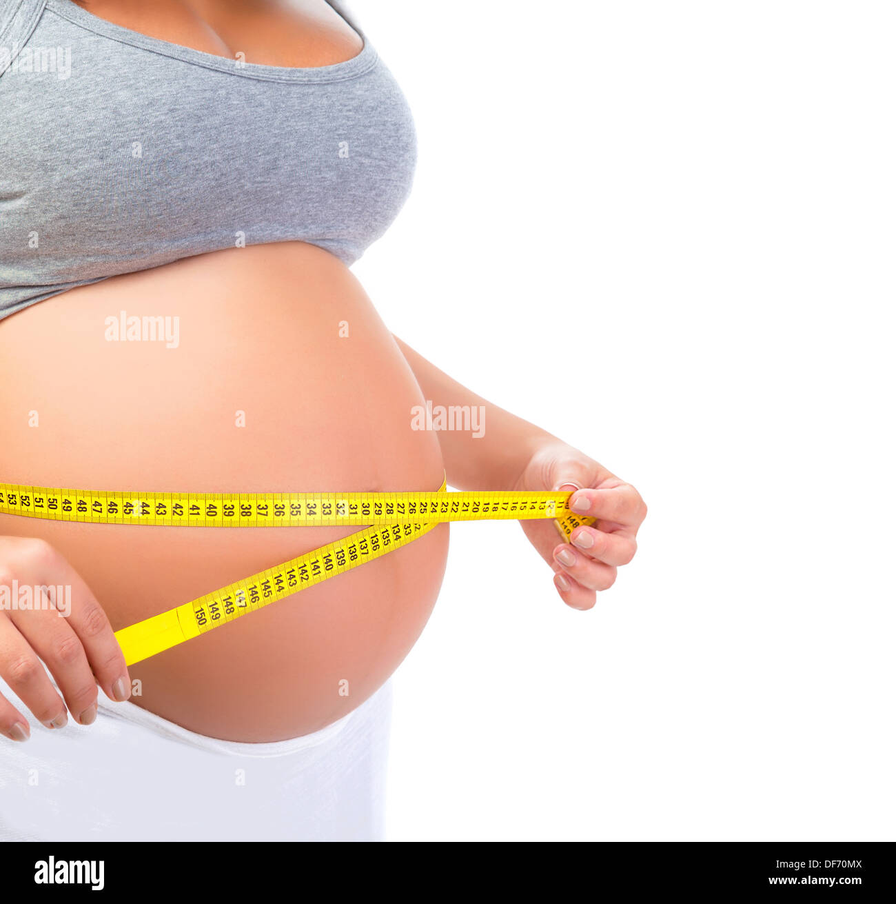 Pregnant female measuring belly, body part, child care, tummy size control, happy young family, new life concept Stock Photo