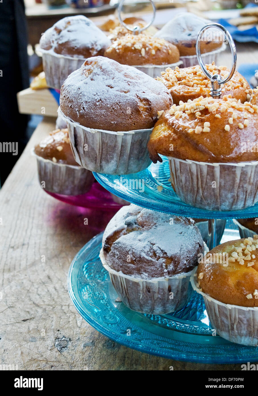Muffins in a vintage tier cake stand on a rustic table. Stock Photo