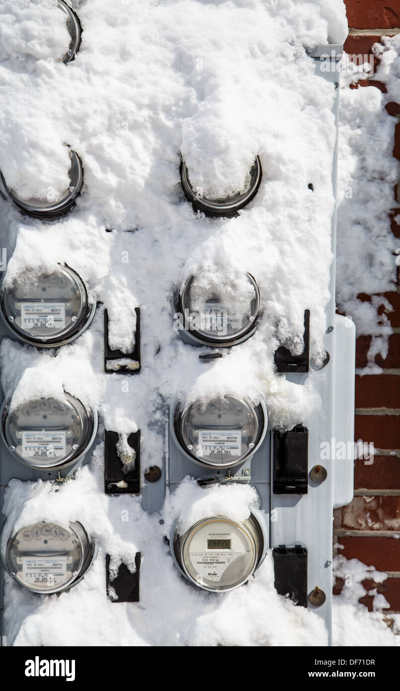 Residential electric meters covered in snow after blizzard Stock Photo